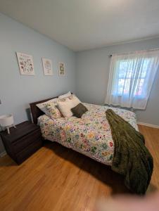 a bedroom with a bed and a window at Summit & Shore House, Whole House in Colchester