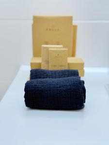 a pile of boxes sitting next to a blue towel at Casa Nizza D'Oro in Castelnuovo +52 photos