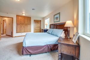 a bedroom with a bed and a table with a lamp at Groups Welcome! Ocean-View Escape in Gold Beach in Gold Beach