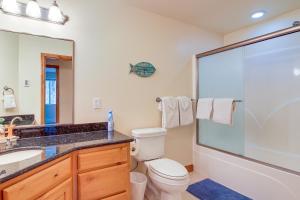 a bathroom with a toilet and a sink and a shower at Groups Welcome! Ocean-View Escape in Gold Beach in Gold Beach +27 photos