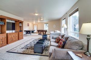 a living room with a couch and a table at Groups Welcome! Ocean-View Escape in Gold Beach in Gold Beach