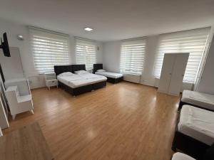 a large room with two beds and a table at HOTEL Aksu GREEN GARDEN in Bucharest