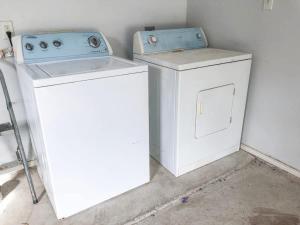 a washer and dryer sitting in a room at BBQ ok Ground Floor Duplex 1-2 block to Beach in South Padre Island
