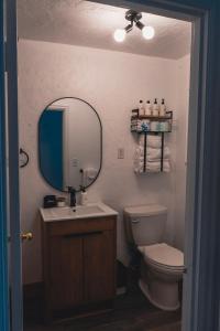 a bathroom with a sink and a toilet and a mirror at The Spinn in Manzanita +39 photos