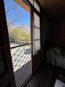 an open door to a bedroom with a view of a mountain at Hostal Casa Rosada, Valle del Elqui in Rivadavia