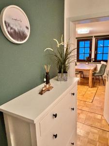 Una cómoda blanca en una habitación con comedor. en Unique apartment near Frankfurt, en Neu Isenburg