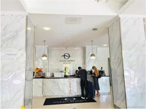 two people standing at a counter in a store at Ocean Reserve Luxury Condo Sunny Isles Beach in Sunny Isles Beach +79 photos