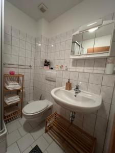 Un baño blanco con lavabo e inodoro. en Olymp Hotel, en Magdeburgo 13 fotos más
