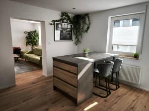 a kitchen with a island in a living room at FeWo Katharina in Bitburg