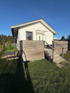 a house with a wooden fence in front of it at Jönåker Cottage & Sauna in Jönåker