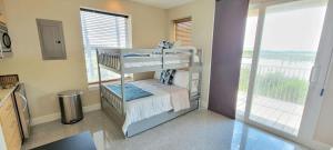 a room with a balcony with a bunk bed at 3 level luxury Beachlike Pool Killer Sunsets in South Padre Island