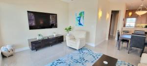 a living room with a television and a dining room at 3 level luxury Beachlike Pool Killer Sunsets in South Padre Island