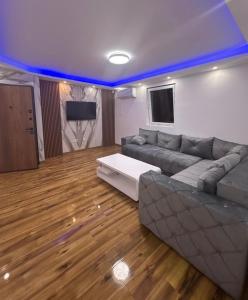 a living room with a couch and a tv at Apartmani AX in Pančevo