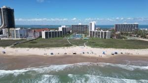an aerial view of a beach in front of a city at Resort like super heated pool & direct beach front in South Padre Island +104 photos