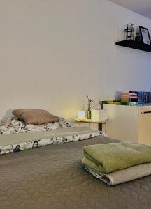 a bedroom with a bed with a blanket on it at Duży apartament z kuchnią i łazienką in Namysłów