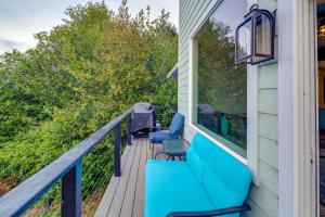 a balcony with blue furniture on a house at Astoria Home Base with River Views, 3 Mi to Dtwn! in Tongue Point Village