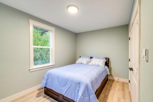 a bedroom with a bed with blue sheets and a window at Astoria Home Base with River Views, 3 Mi to Dtwn! in Tongue Point Village +18 photos