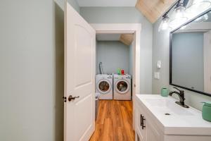 a bathroom with a washing machine and a sink at 4 Blocks to Riverwalk Updated Astoria Studio in Tongue Point Village