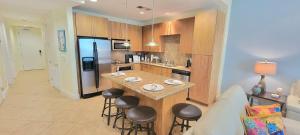 a kitchen with a island in the middle of a room at Luxury 17th Floor Beachfront Stunning Views in South Padre Island
