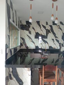 una cucina con ripiano in marmo e sedie in legno di Your New Home a Belém