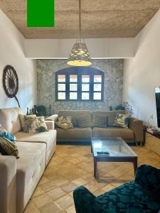 a living room with a couch and a coffee table at Pousada Villa do Sol Taiba in Taíba