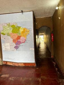a hallway with a large map on a wall at Guest House BH in Belo Horizonte