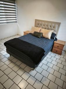 クエルナバカにあるcasa agradableのベッドルーム1室(青い毛布、テーブル付)