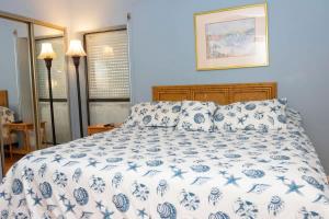 a bedroom with a blue and white bed with pillows at Heart of Entertainment District Pet Friendly in South Padre Island +7 photos