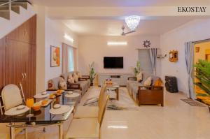 a living room with a couch and a table at EKOSTAY - Fern Wood Villa 