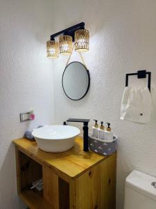a bathroom with a sink and a mirror at The GRΣΣK Cottage in Kingstown