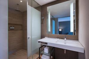 a bathroom with a white sink and a mirror at AC Hotel by Marriott Santa Fe in Mexico City