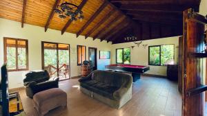 a living room with a pool table and a couch at Luxury Villa Heated Pool, Firepit & Pool Table in Arroyo Frío