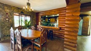 a dining room with a wooden table and chairs at Luxury Villa Heated Pool, Firepit & Pool Table in Arroyo Frío
