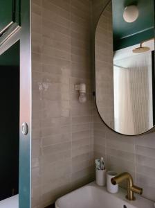 a bathroom with a sink and a mirror at Cosy Strasbourg centre in Strasbourg