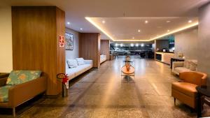 a living room with couches and a table in a room at El Aram Beach Boa Viagem in Recife
