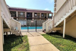 a building with a gate and a swimming pool at Great Location Pool Near the Beach in South Padre Island +67 photos