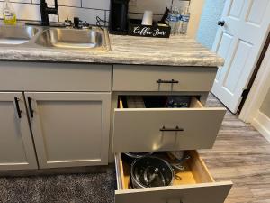 a kitchen counter with drawers and a sink at Quiet 3 Bedroom home Near downtown in Lansing +22 photos