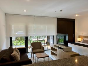 a hotel room with a bed and a bed and a tv at Suites - Llanogrande in Rionegro +6 photos