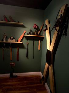 a room with a shelf and weapons on a wall at The Alchemy in Bournemouth