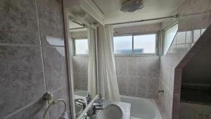 a bathroom with a shower and a tub and a sink at Casona Quintamar 6 norte in Viña del Mar +45 photos