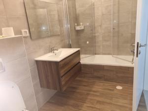 a bathroom with a tub and a sink and a shower at Beach Suite Israel- Private Jacuzzi Sea View Balcony, Off-Site Spa ביץ סוייט ישראל- ג'קוזי פרטי עם נוף ים, אפשרות לספא מוזל in Ashqelon