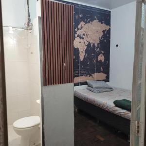 a small room with a bed and a toilet at Guest House BH in Belo Horizonte