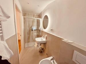 a bathroom with a sink and a toilet and a mirror at Hotel Pex Verona in Verona