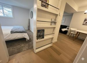 a bedroom with a bed and a book shelf at Cedar & Sage Suite the Cozy Retreat with Full Kitchen in Victoria