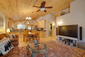 a living room with a large flat screen tv at Near Hikes Arnold Cabin with EV Charger and Fire Pit in Arnold