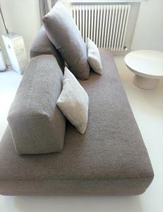 a couch with three pillows on top of it at Villa Maria in Onno