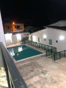 a swimming pool in the middle of a building at night at Pousada SB in Campo Formoso +22 photos