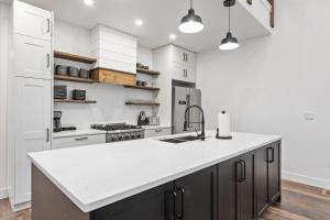 a kitchen with white appliances and a large white counter top at Alpine Glow Ski Haus in Whitefish