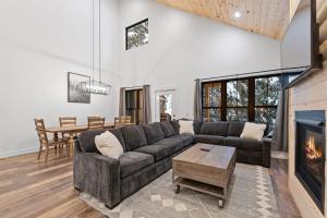 a living room with a couch and a fireplace at Alpine Glow Ski Haus in Whitefish