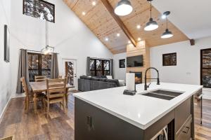 a kitchen and living room with a table and a couch at Alpine Glow Ski Haus in Whitefish +30 photos
